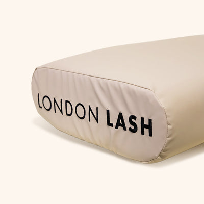 Beige Faux-leather Memory Foam Lash Pillow with branding