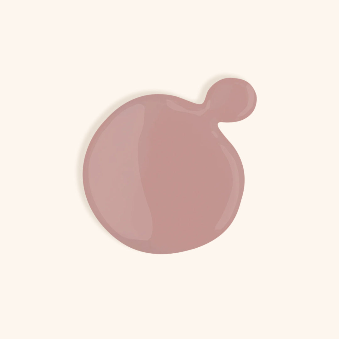 Mauve nude gel nail polish shade against light background
