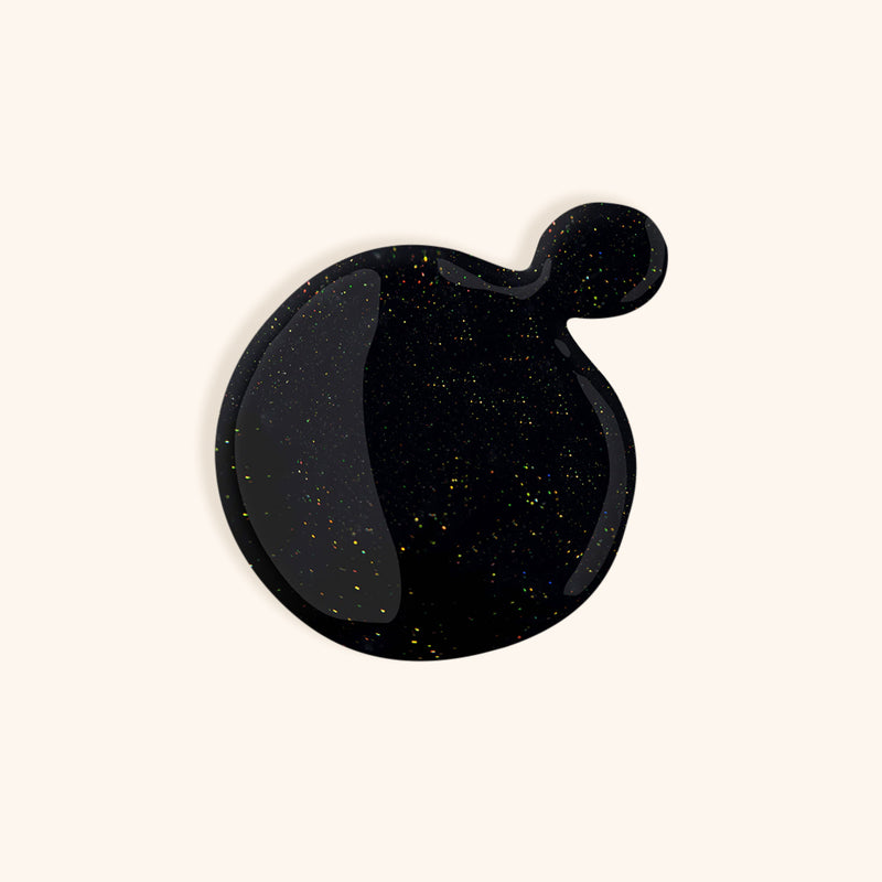 Dark black gel nail polish with silver shimmer in front of a light background