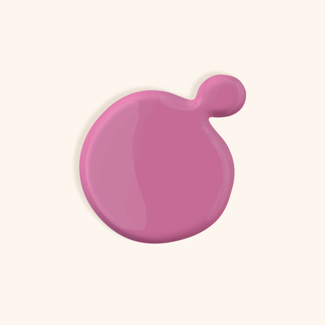 Mauve pink nail polish in front of a beige background