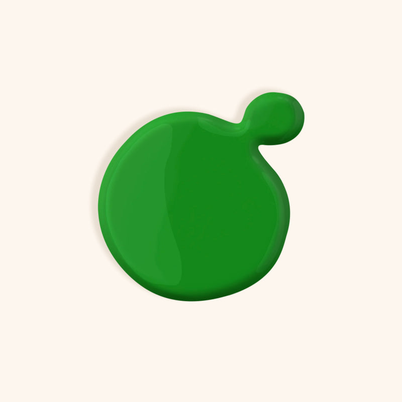 Bright green nail polish in front of a beige background