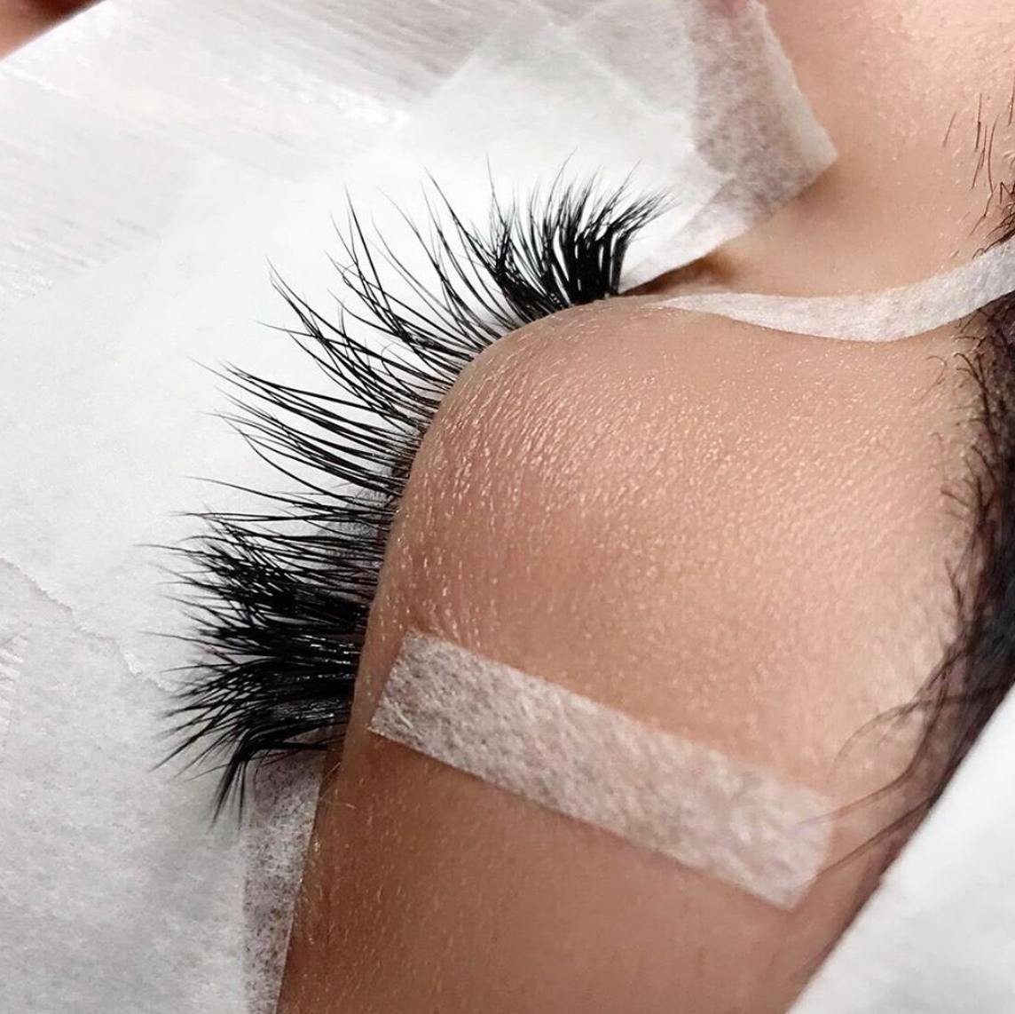 Lash Tech using 3M Micropore Tape during lash extensions treatment
