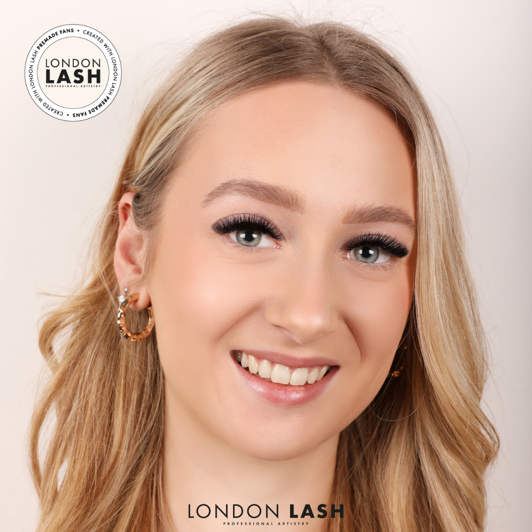 Blonde haired woman wearing eyelash extensions using premade lashes